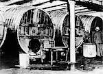 1920s 1930s PROHIBITION FEDERAL AGENT STANDS BESIDE BEER BATS AT ILLEGAL DISTILLERY IN ONE OF LARGEST RAIDS JULY 22 1931