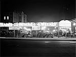 1920s 1930s NEW AND USED CAR LOT NIGHT NEW YORK CITY GREENWICH VILLAGE AUTO AUTOMOTIVE AUTOMOBILE SALES SIXTH AVENUE AND WAVERLY STREET