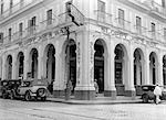 1940s OUTSIDE FACADE OF SLOPPY JOES BAR IN HAVANA NEON SIGNS PEOPLE AND CARS IN STREET