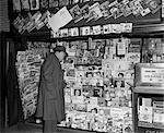 1950s NEWSSTAND WITH MAN BUYING MAGAZINE