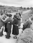 1950s GROUP OF MEN AND WOMEN DANCING IN A RURAL ROAD NEAR BANTRY IRELAND OUTDOOR