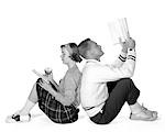 1950s 1960s TEENAGE HIGH SCHOOL COUPLE BOY & GIRL STUDENTS LEANING BACK TO BACK DATING STUDYING READING BOOKS