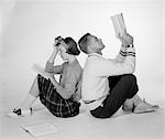 1950s COUPLE TEEN BOY GIRL SITTING BACK TO BACK READING BOOKS STUDYING