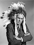 1960s PORTRAIT MAN WEARING INDIAN CHIEF FEATHERED HEADDRESS