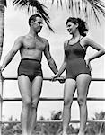 1940s COUPLE IN BATHING SUITS STANDING TALKING