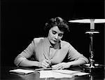 1950s WOMAN AT DESK WRITING CHECK PEN LAMP FINANCE PAYING BILLS BUDGET