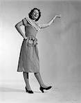 1950s WOMAN IN POLKA DOT DRESS ARM ON HIP WITH EXPRESSION