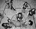 1980s BIRD'S EYE VIEW OF GROUP OF KIDS PLAYING BASKETBALL ONE JUMPING UP TO SHOOT A BASKET BALL GOING INTO NET