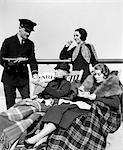 1930s THREE WOMEN BEING SERVED TEA BY A STEWARD ON BOARD AN OCEAN LINER CROSSING THE ATLANTIC OCEAN