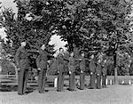 1940s 8 MEN IN UNIFORM STANDING IN ROW MILITARY UNIFORM ARMY ROTC TRAINING COMMAND COLLEGE CAMPUS