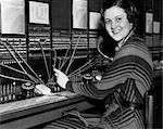 1930s WOMAN TELEPHONE OPERATOR AT SWITCHBOARD