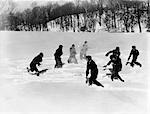 1930s GROUP 8 BOYS HAVING A MASSIVE SNOWBALL FIGHT NEAR WOODS