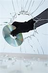 Hand Stealing CD Through Broken Glass