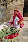 Woman selling flowers outside the Jain Temple of Chaumukha, Rajasthan, India