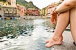 Woman Sitting by Water, Near Beach in Vernazza, Liguria, Italy
