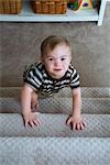 Boy with Down Syndrom Climbing up Stairs