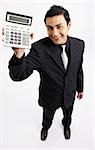 man holding up calculator, smiling