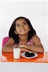 Girl with milk and cookies