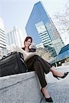 Businesswoman Sitting Outdoors Talking on Cell Phone