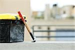 Plastic toolbox, hammer on ledge