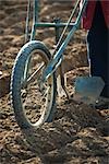 Farmer behind plow turning soil in field