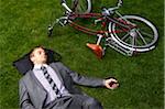 Businessman Lying on Grass