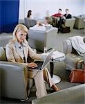 Businesswoman Using Laptop in Lounge
