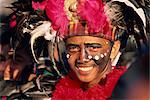 Portrait of a man with facial decoration and head-dress with feathers at Mardi Gras carnival, Dinagyang in Iloilo City on Panay Island, Philippines, Southeast Asia, Asia