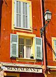 Architectural detail of lamp and shuttered windows above a restaurant awning, Old Town, Nice, Alpes Maritimes, Provence, French Riviera, France, Europe