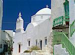 Close-up of green balcony with whitewashed walls, dome and bell tower of church beyond in The Kastro village, Folegandros, Cyclades, Greek Islands, Greece, Europe