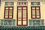 Close-up of closed shutters on doors and windows and decorative panels on the front of a house in Singapore, Southeast Asia, Asia