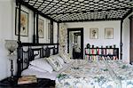 Colonial style bed with lattice roof and decorative botanical paintings in residential home, Dehra Dun, Himalayan foot hills, Uttar Pradesh, India, Asia