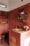 Pink finished plaster walls and hand beaten brass bathroom sink, residential home, Amber, near Jaipur, Rajasthan state, India, Asia