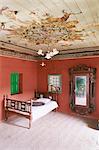 Traditional mud floor contrasting with the magnificently painted ceiling in restored traditional Pol house, Ahmedabad, Gujarat state, India, Asia