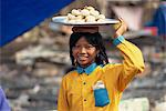 Young girl carrying plate on head, Phnom Penh, Cambodia, Indochina, Southeast Asia, Asia