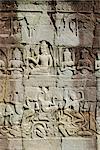 Stone bas-reliefs depicting scenes of rural life and historical events, in the Bayon Temple complex, Angkor, Siem Reap, Cambodia