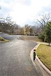 Boy Standing near Curb of Neighborhood Street, Austin, Texas, USA