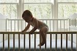 Baby Boy Climbing Out of Crib