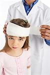 Doctor Wrapping Bandage Around Girl's Head