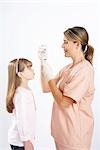 Little Girl Watching Nurse Prepare a Needle