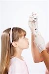 Little Girl Watching Nurse Prepare a Needle