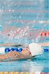 Swimmer doing backstroke in competition