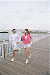 Young couple jogging on bridge