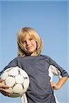 Boy posing with football under arm