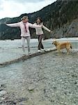 Two women walking at lake