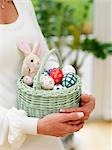 Woman holding basket with easter eggs