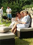 Women looking at photos on garden party