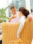 Two girls sitting in armchair