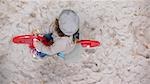 child playing in sand, view from above