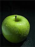 green apple with drops, close-up